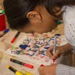 A young girl makes art at an activity table at East Liberty Celebrates MLK 2015.