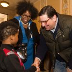 Mayor Bill Peduto shakes hands with a young guest at East Liberty Celebrates MLK